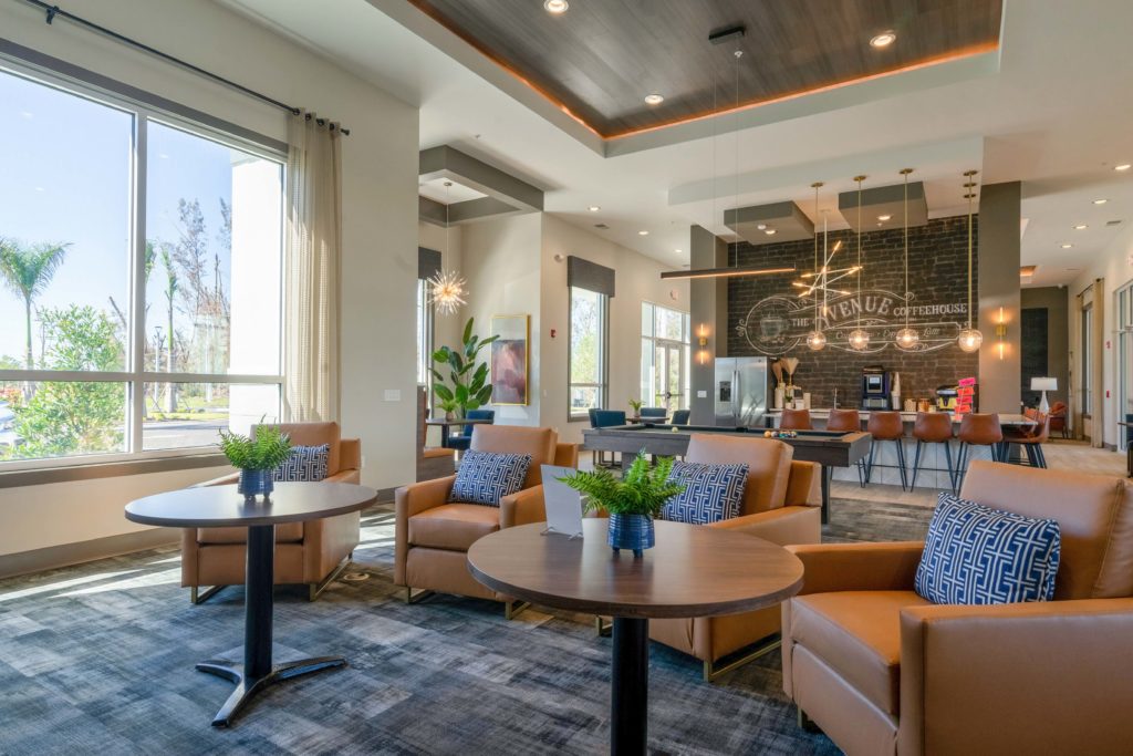 Interior clubhouse with designer and natural lighting, lounge seating, carpet flooring, and pool table